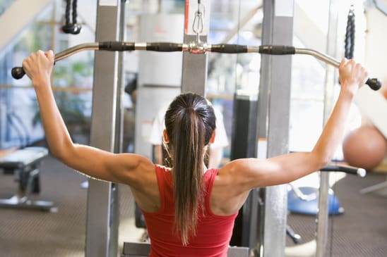 Woman Weight Training At Gym