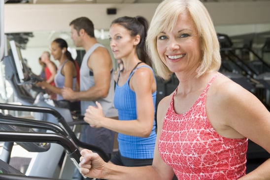 Woman Running On Treadmill At Gym