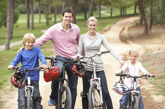 Family enjoying bike ride in park