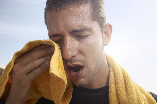 sweating young man with a towel