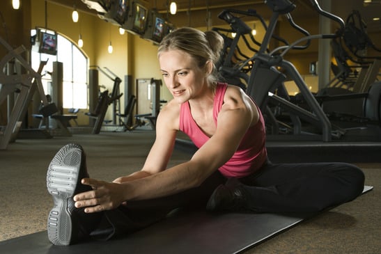 Woman stretching at gym.