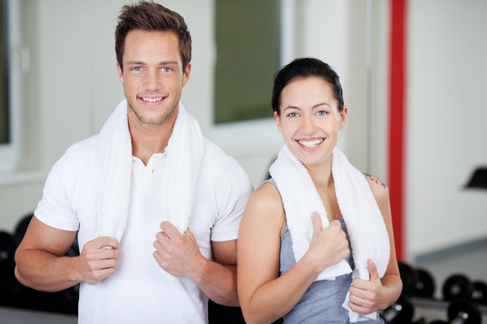 Couple With Towels Standing Together In Gym