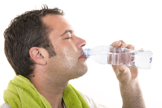 man drinking water and sweating