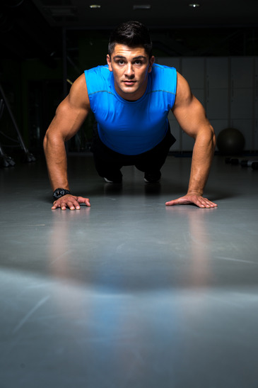 Man exercising in gym push ups