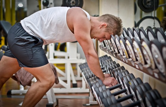 Handsome young man resting after workout in gym