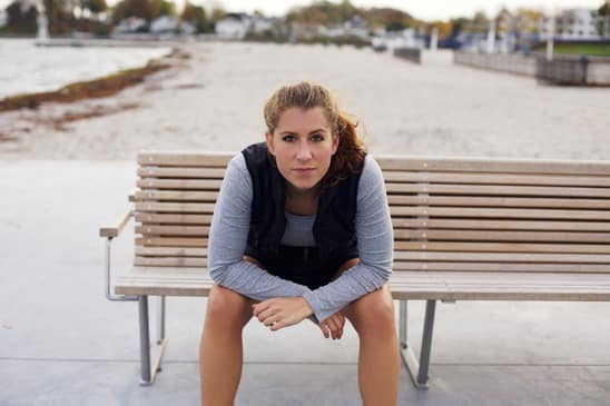 Beautiful young woman taking a break from running