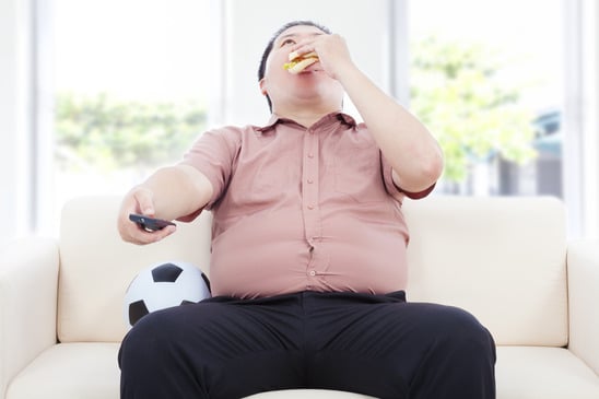 photodune-7936721-fat-business-man-drinking-beer-and-sitting-on-sofa-to-watch-tv-at-home-xs