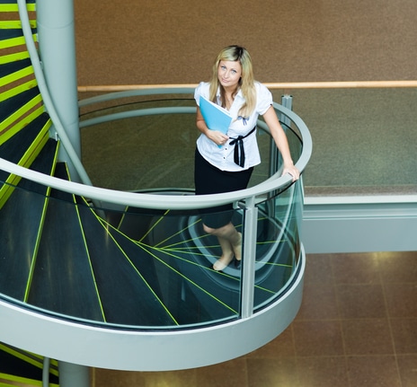 Businesswoman walking up stairs in office