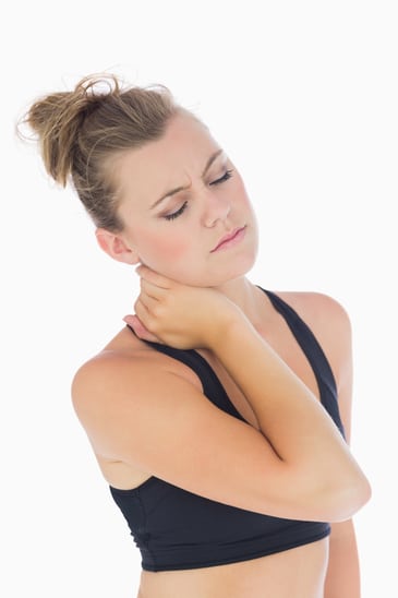 photodune-8442143-woman-holding-hand-to-stiff-neck-with-eyes-closed-in-sportswear-xs