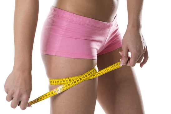 photodune-9346580-young-woman-measuring-her-thigh-xs