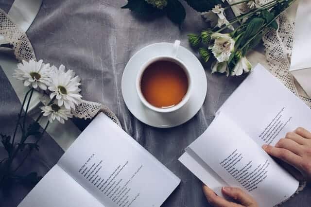 white-ceramic-teacup-with-saucer-near-two-books-above-gray-904616