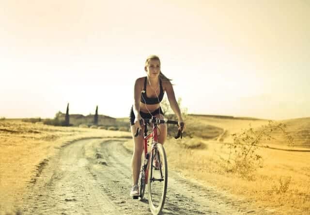 woman-in-black-sports-bra-and-shorts-riding-bicycle-3769698