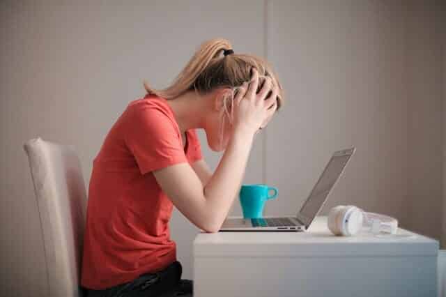 woman-in-red-t-shirt-looking-at-her-laptop-3755761
