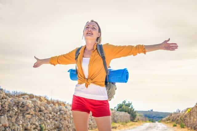 woman-in-yellow-long-sleeve-standing-under-the-sunlight-3779756