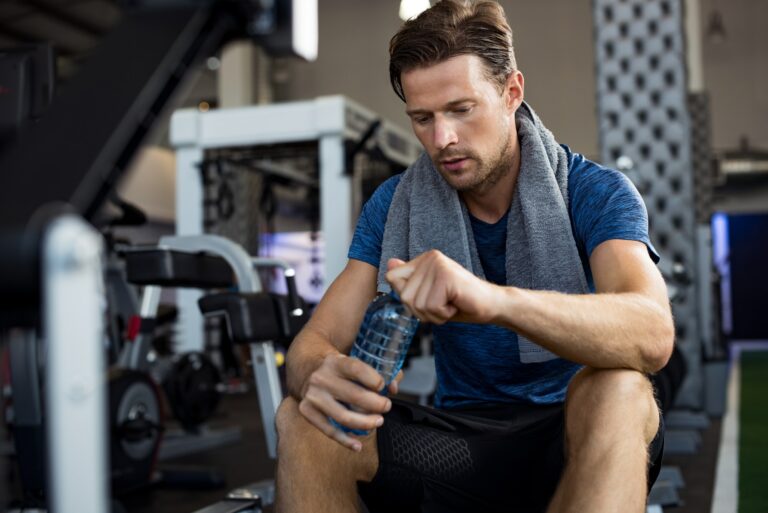 Man with water bottle at gym